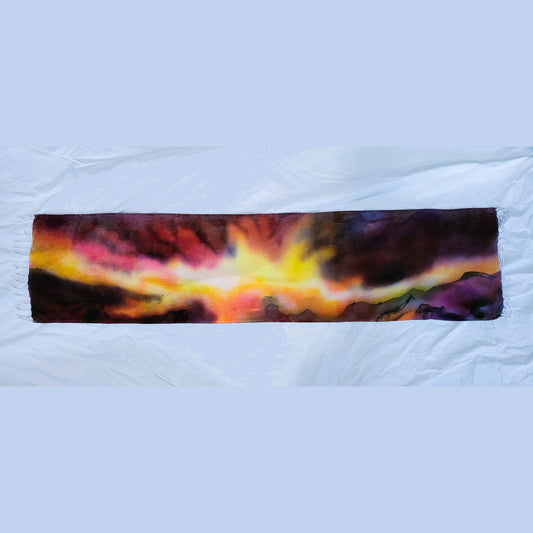 Hand-painted wearable rayon scarf featuring nebula-inspired sunrise colors with subtle black mountain line work by Amy Bridges
