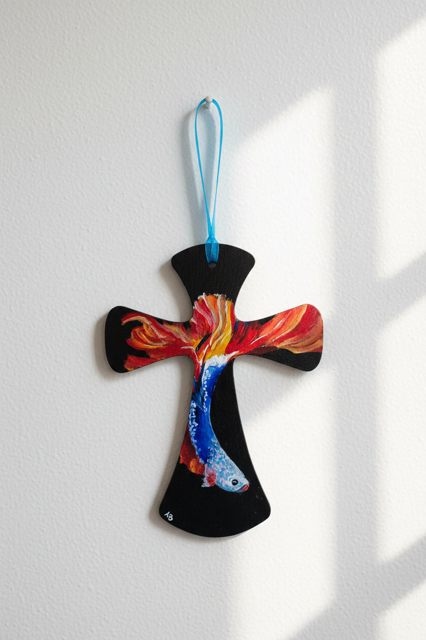 Hand-painted wooden wall cross with flowing betta fish in blue, silver, gold, and red on black background