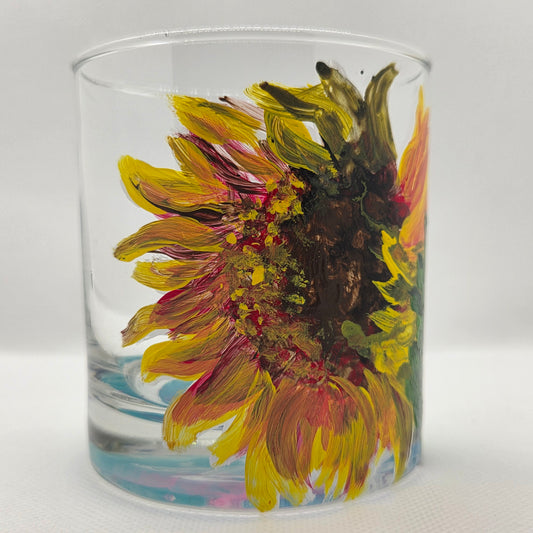 Hand-painted 11 oz highball glass featuring a detailed sunflower design with warm yellow, orange, and red tones inspired by wildflowers.