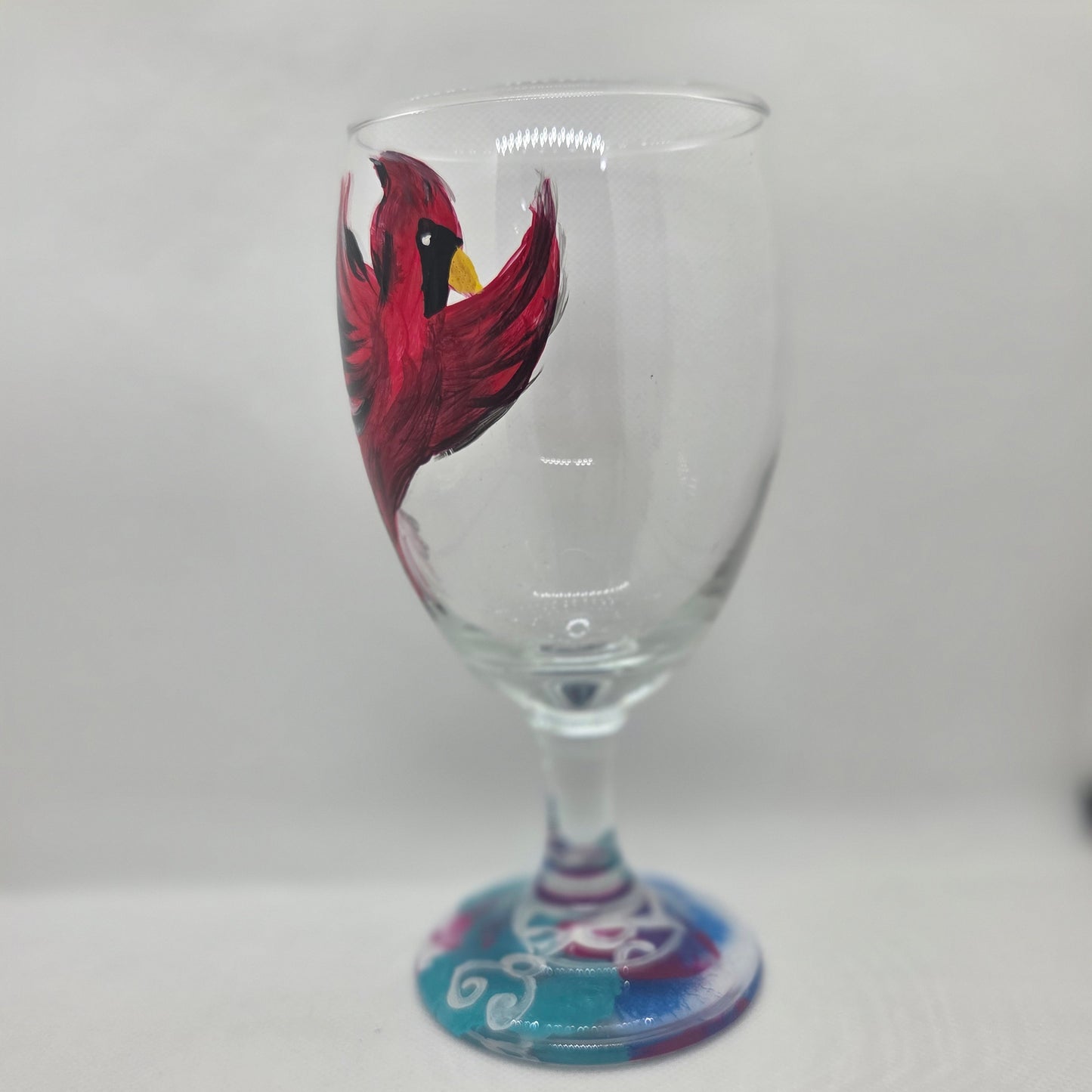 Hand-painted 16 oz goblet featuring a complete red cardinal in flight with bold black and white details