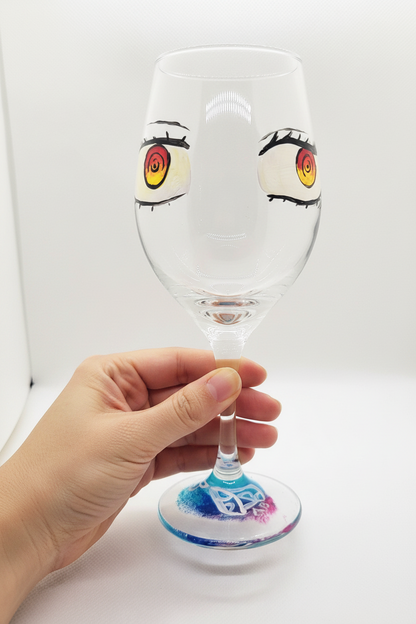 Hand-painted 12 oz dessert wine glass featuring stylized red manga-inspired spiral eyes by Amy Bridges