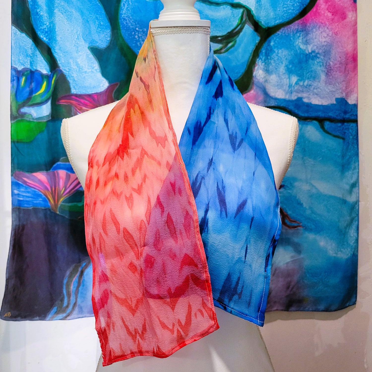 Hand-dyed silk chiffon scarf featuring red blue and gold horizon tones created with pole-wrapping resist dye technique wearable art by Amy Bridges.