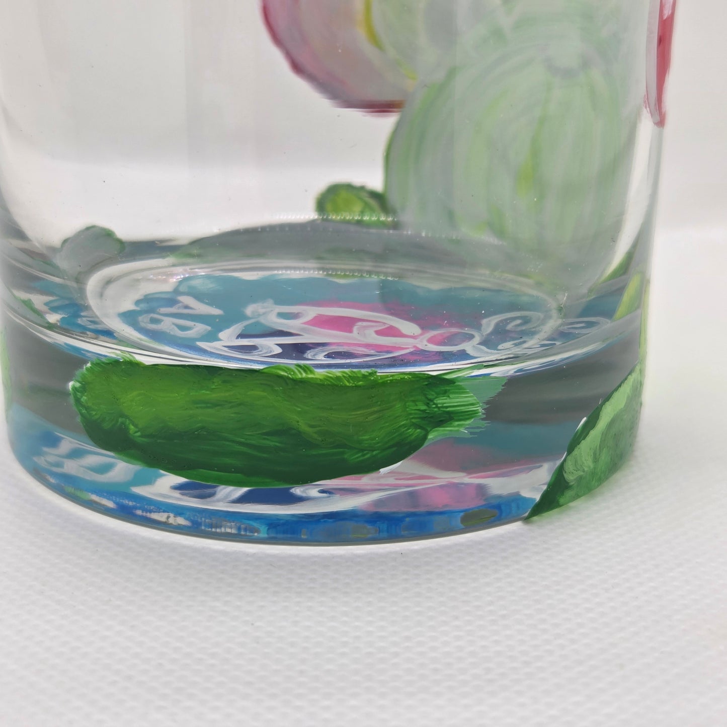Hand-painted 11 oz highball glass featuring a whimsical frog sitting on a lily pad wearing a red mushroom hat with lily pad details wrapping around the glass.