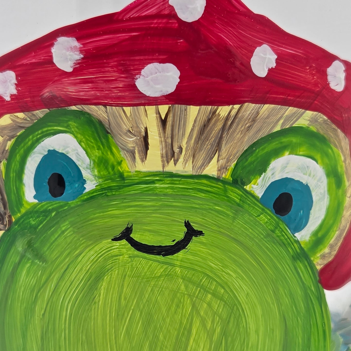 Hand-painted 11 oz highball glass featuring a whimsical frog sitting on a lily pad wearing a red mushroom hat with lily pad details wrapping around the glass.