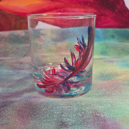 Hand-painted 11 oz short tumbler with a drifting cardinal feather in red, cobalt blue, and deep purple