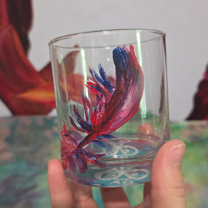 Hand-painted 11 oz short tumbler with a drifting cardinal feather in red, cobalt blue, and deep purple
