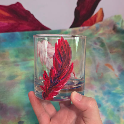 Hand-painted 11 oz short tumbler with two cardinal feathers in red, cobalt blue, and deep purple, one rising and one falling