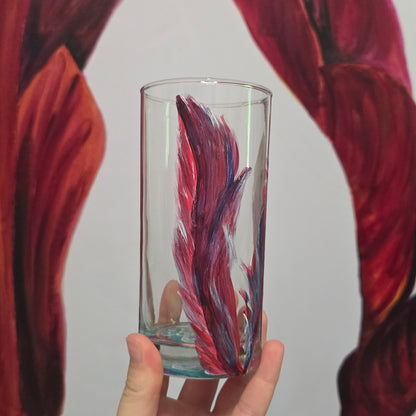 Hand-painted 16 oz tall tumbler with two flowing cardinal feathers in deep red, purple, cobalt blue, and white