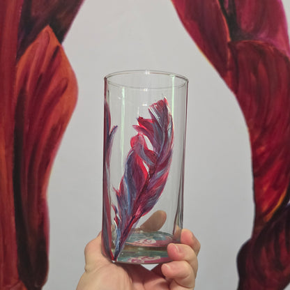 Hand-painted 16 oz tall tumbler with two flowing cardinal feathers in deep red, purple, cobalt blue, and white