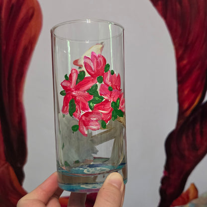 Hand-painted 16 oz tall tumbler with a female cardinal perched on a flowering branch surrounded by red, white, blue, and pink blossoms