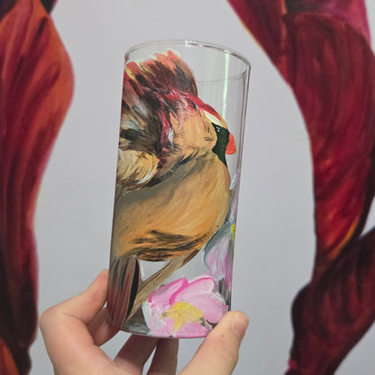 Hand-painted 16 oz tall tumbler with a female cardinal spreading her wings among large pink blossoms