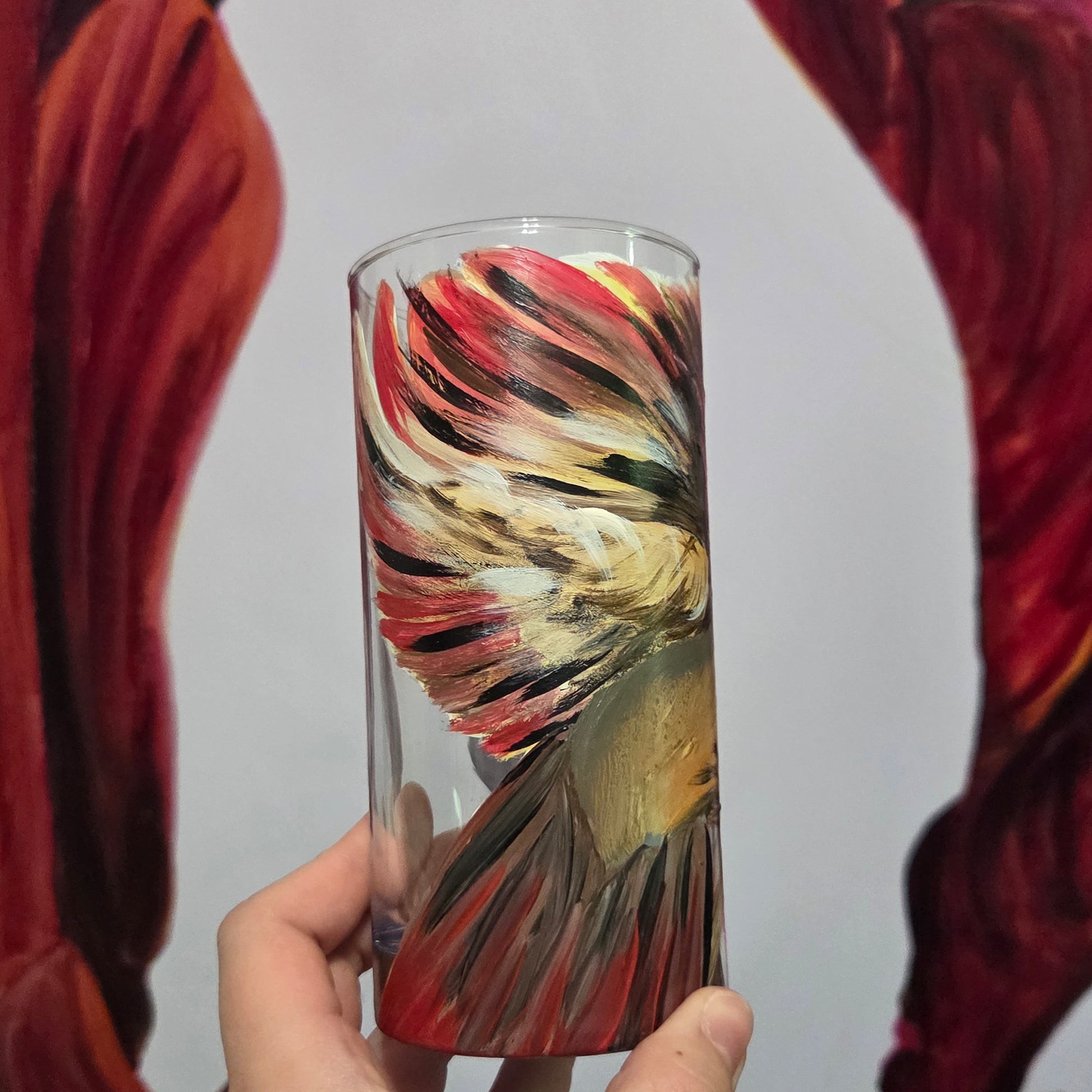 Hand-painted 16 oz tall tumbler with a female cardinal spreading her wings among large pink blossoms