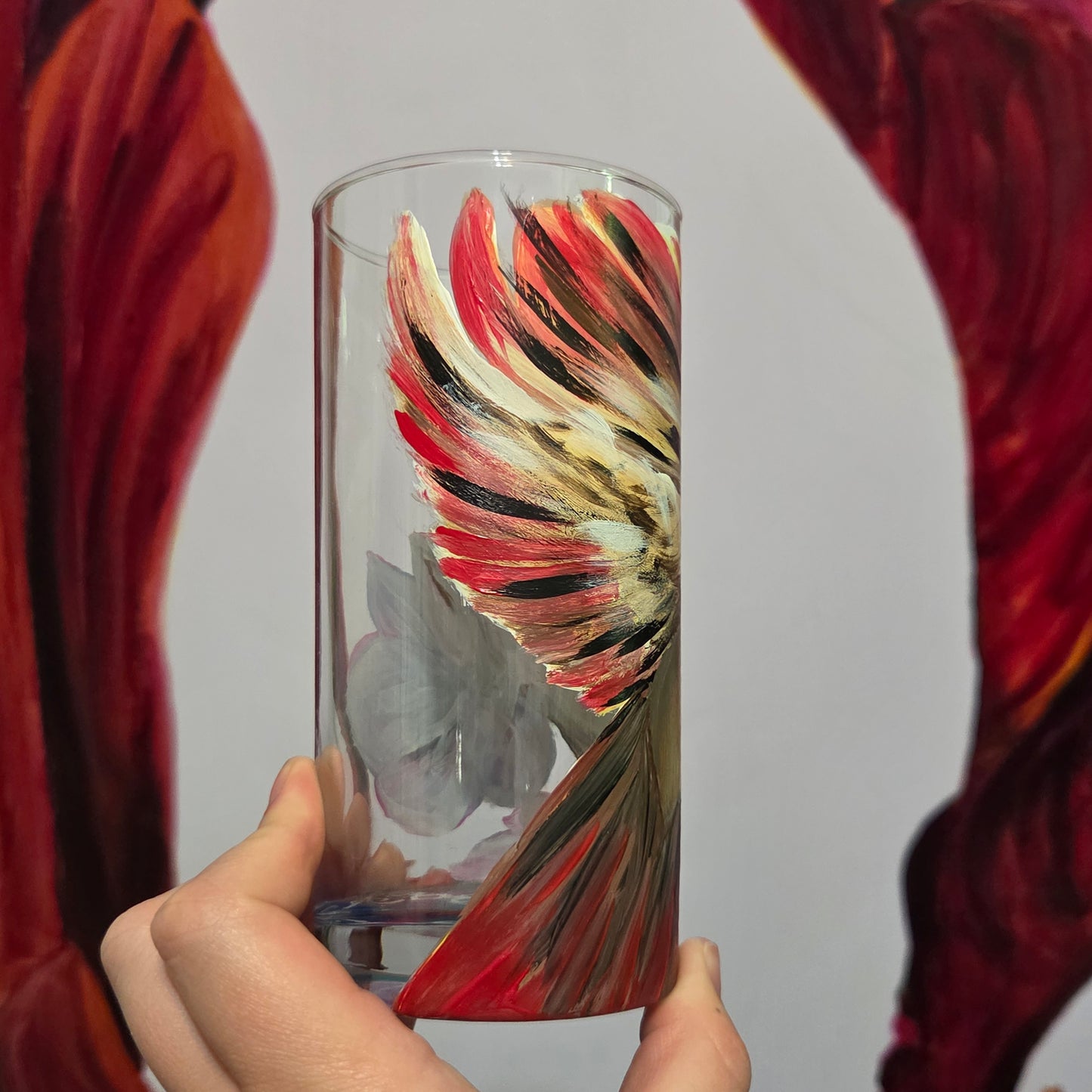 Hand-painted 16 oz tall tumbler with a female cardinal spreading her wings among large pink blossoms