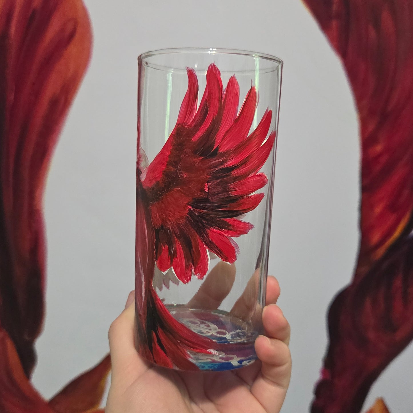 Hand-painted 16 oz tumbler featuring a bold red cardinal facing forward with wings spread wide