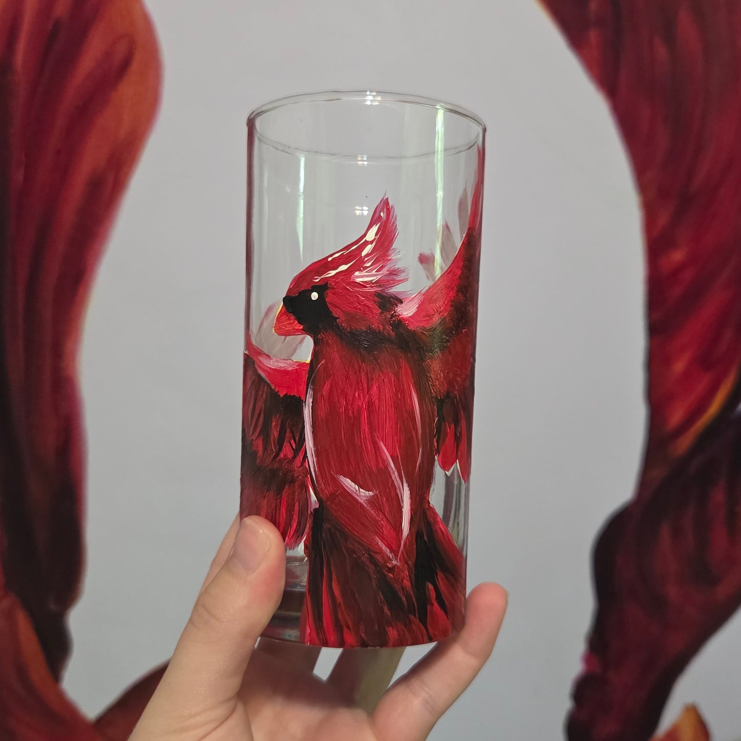 Hand-painted 16 oz tumbler featuring a bold red cardinal facing forward with wings spread wide