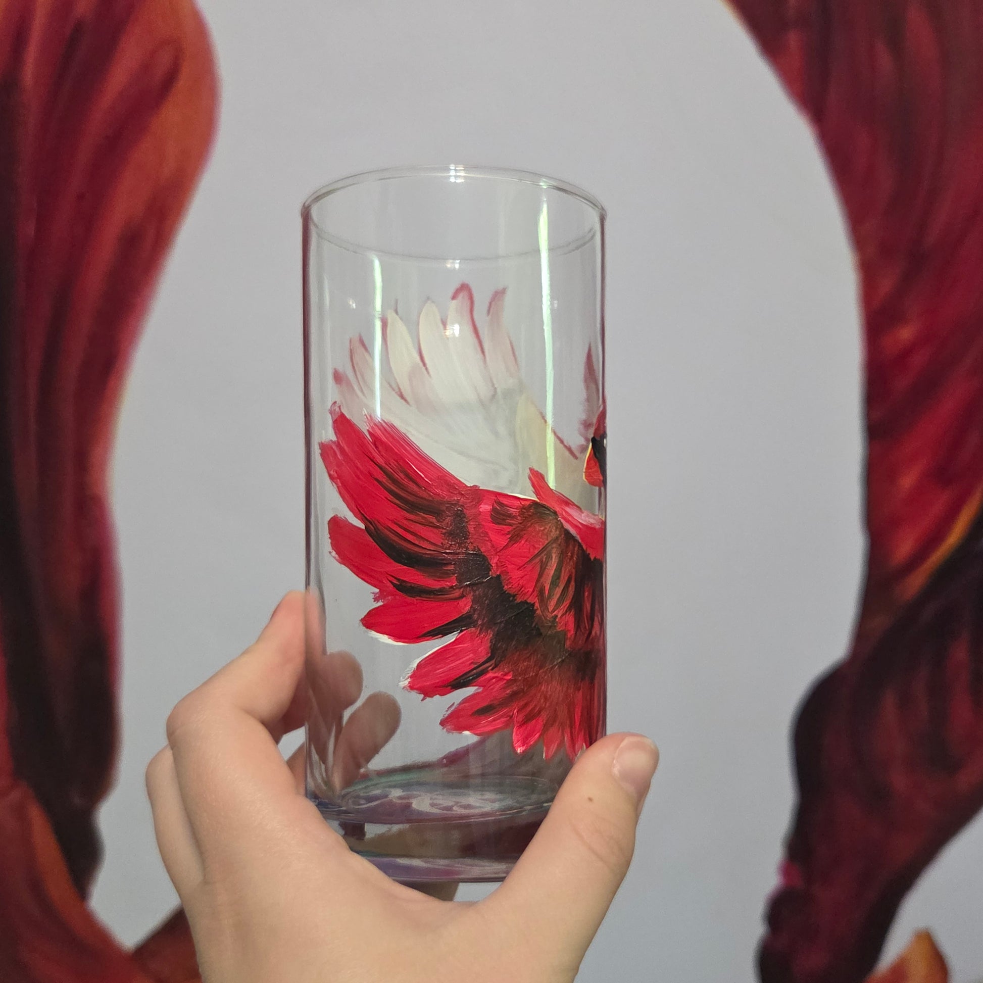 Hand-painted 16 oz tumbler featuring a bold red cardinal facing forward with wings spread wide
