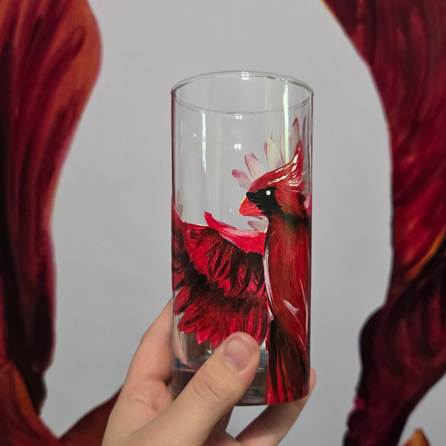 Hand-painted 16 oz tumbler featuring a bold red cardinal facing forward with wings spread wide