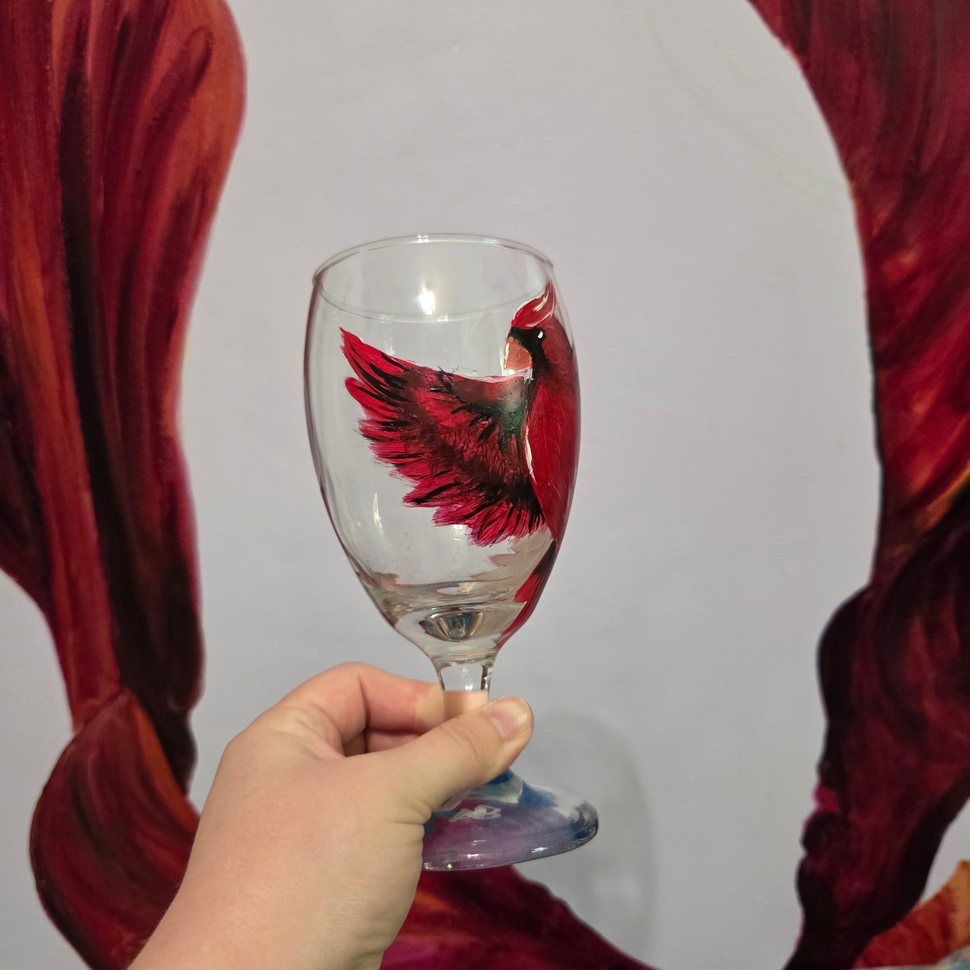 Hand-painted 16 oz goblet with a bold red cardinal facing forward and spreading his wings