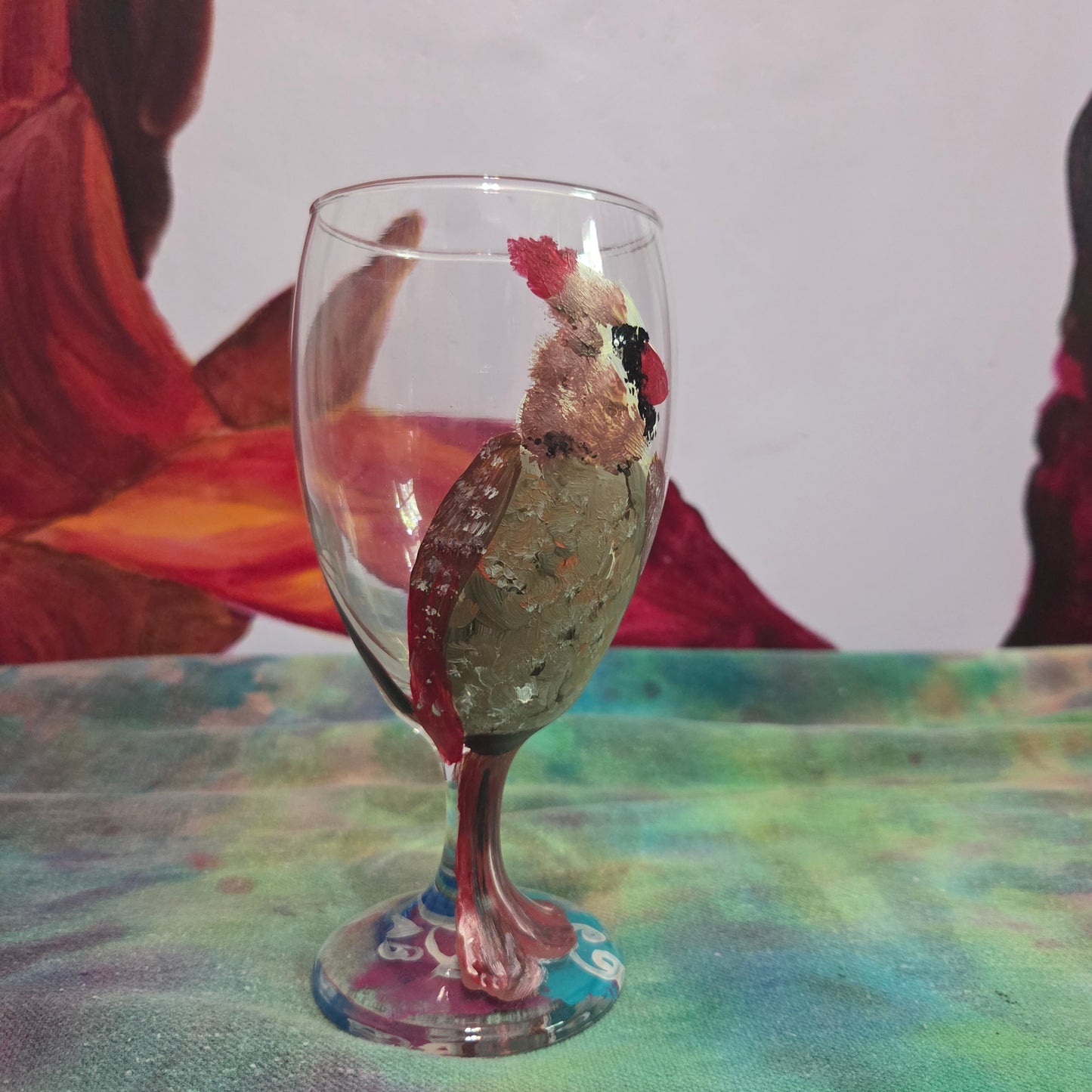 Hand-painted 16 oz goblet with a fluffy female cardinal perched on the bowl and tail feathers extending down the stem