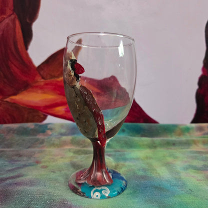 Hand-painted 16 oz goblet with a fluffy female cardinal perched on the bowl and tail feathers extending down the stem