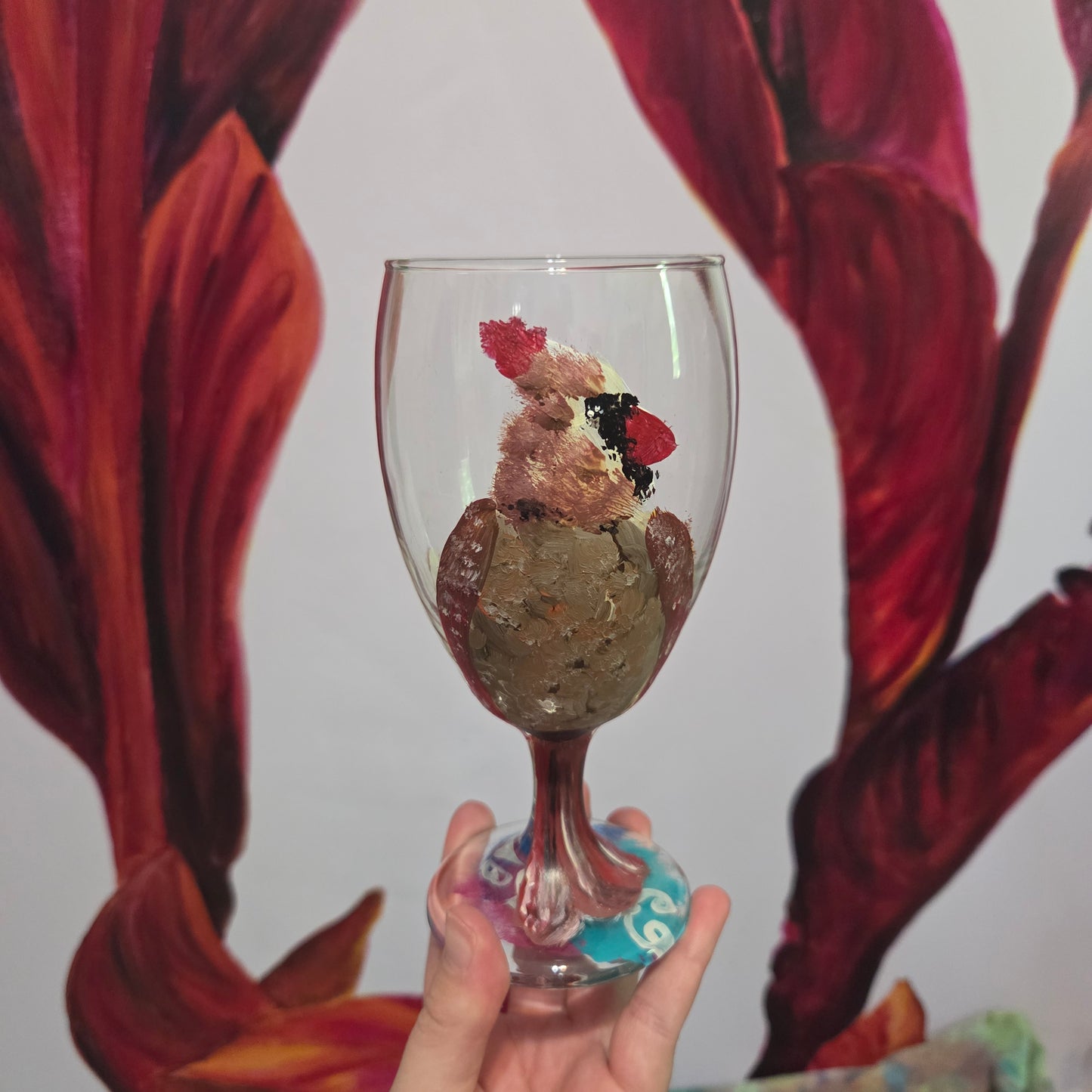 Hand-painted 16 oz goblet with a fluffy female cardinal perched on the bowl and tail feathers extending down the stem