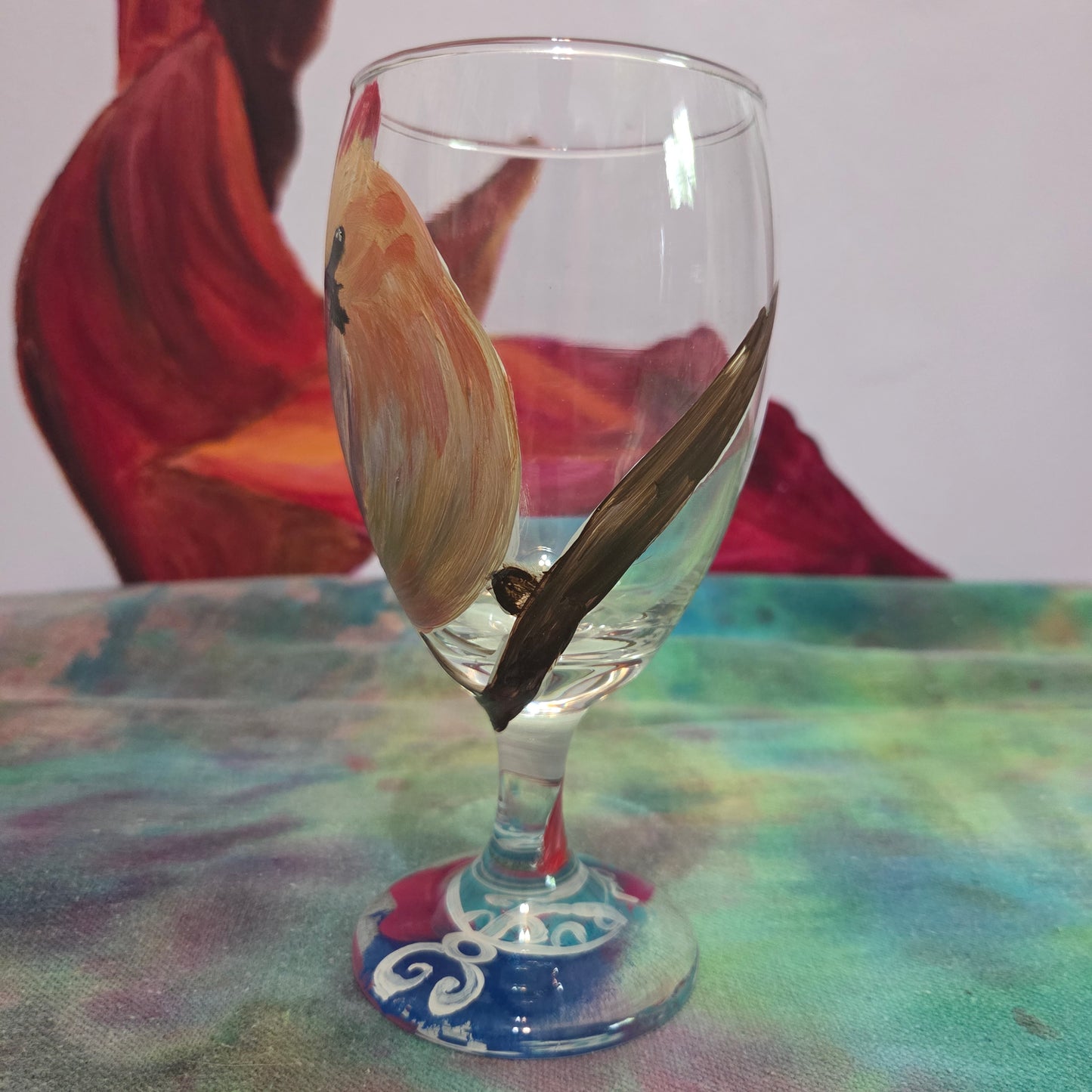 Hand-painted 16 oz goblet with a female cardinal looking over her shoulder, perched on a branch with peach-pink coloring