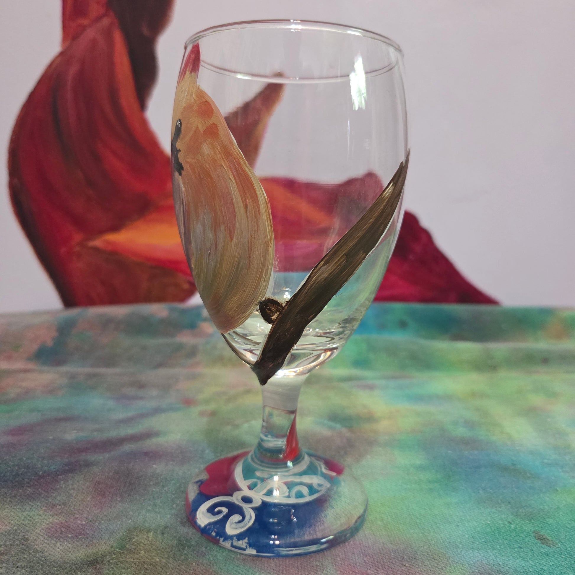 Hand-painted 16 oz goblet with a female cardinal looking over her shoulder, perched on a branch with peach-pink coloring