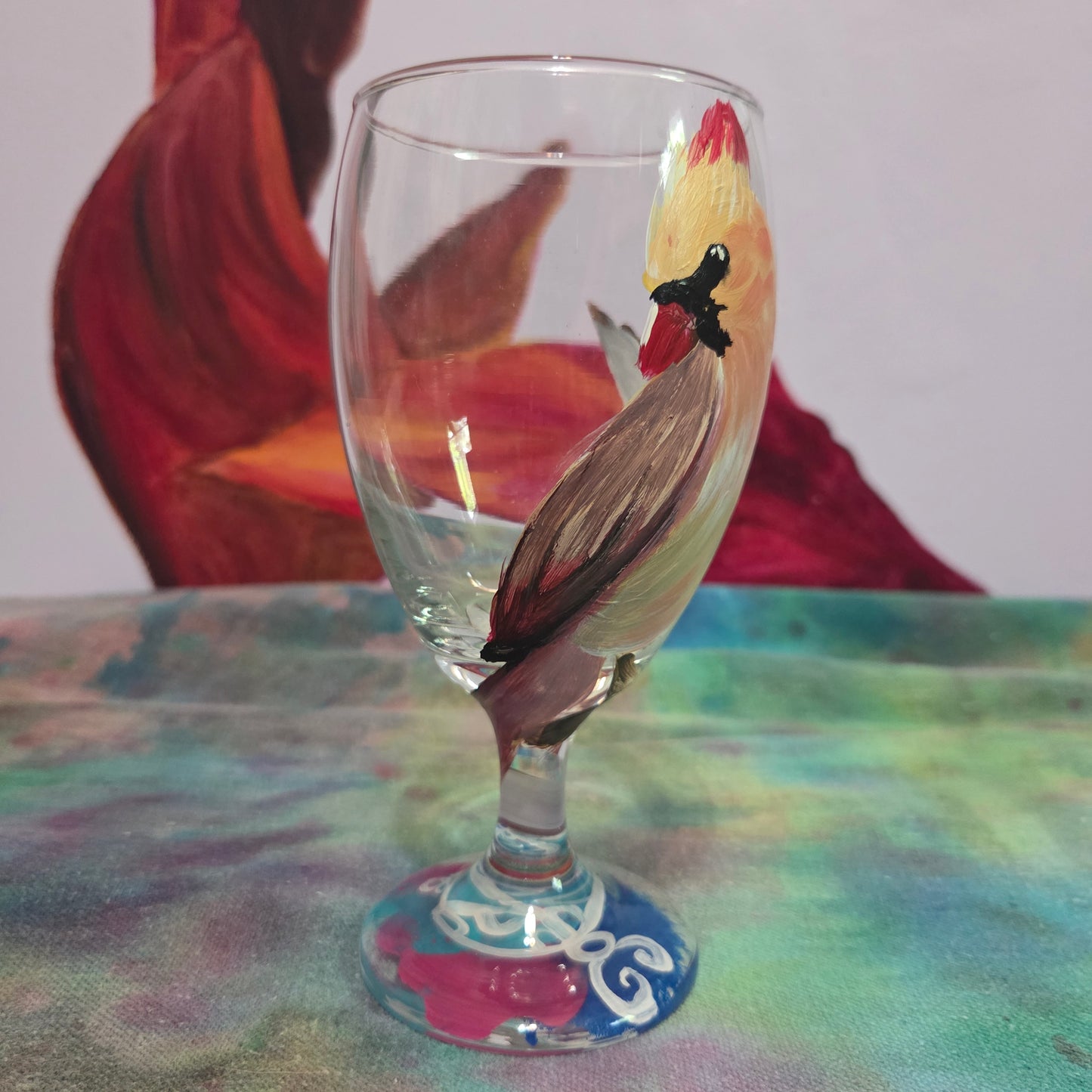Hand-painted 16 oz goblet with a female cardinal looking over her shoulder, perched on a branch with peach-pink coloring
