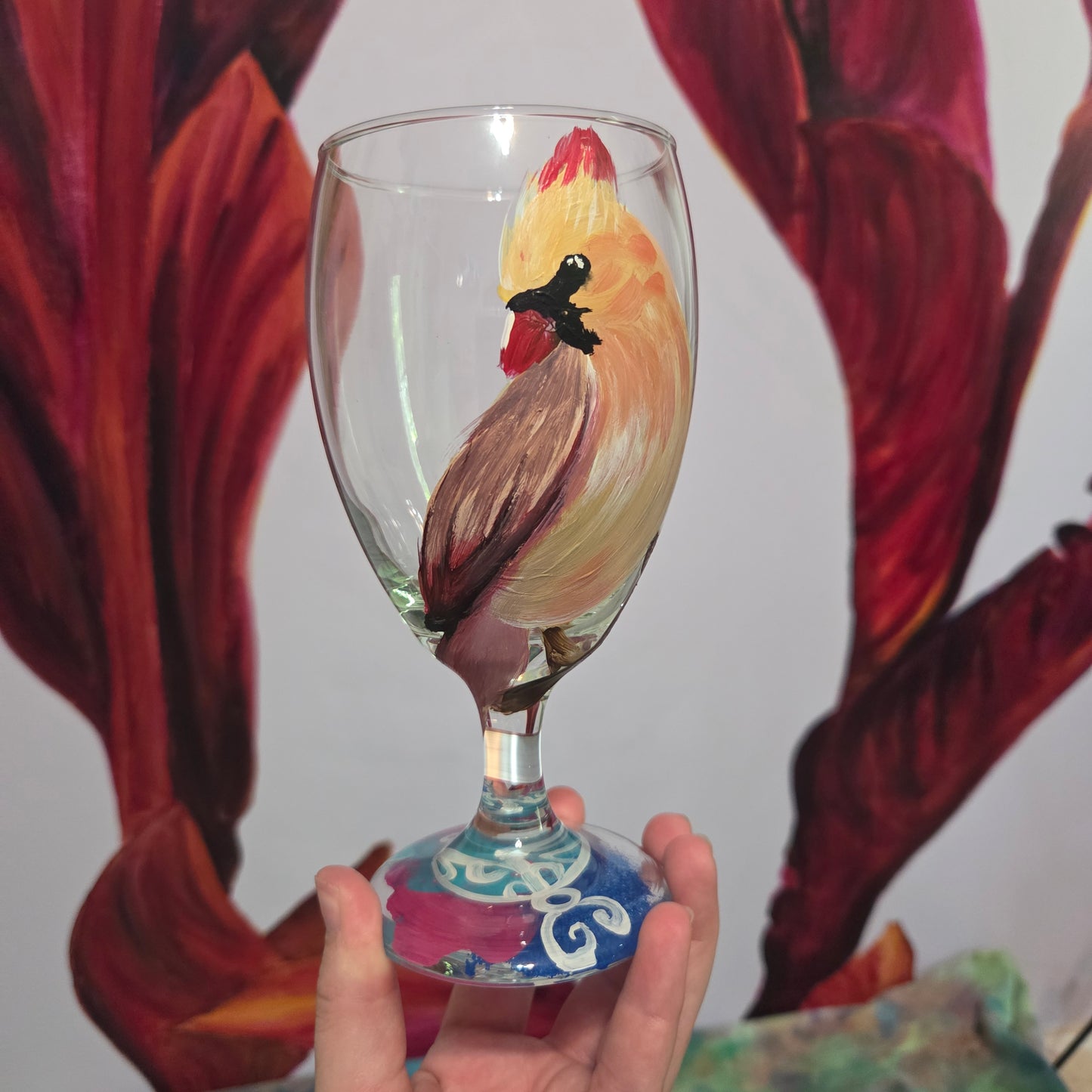 Hand-painted 16 oz goblet with a female cardinal looking over her shoulder, perched on a branch with peach-pink coloring