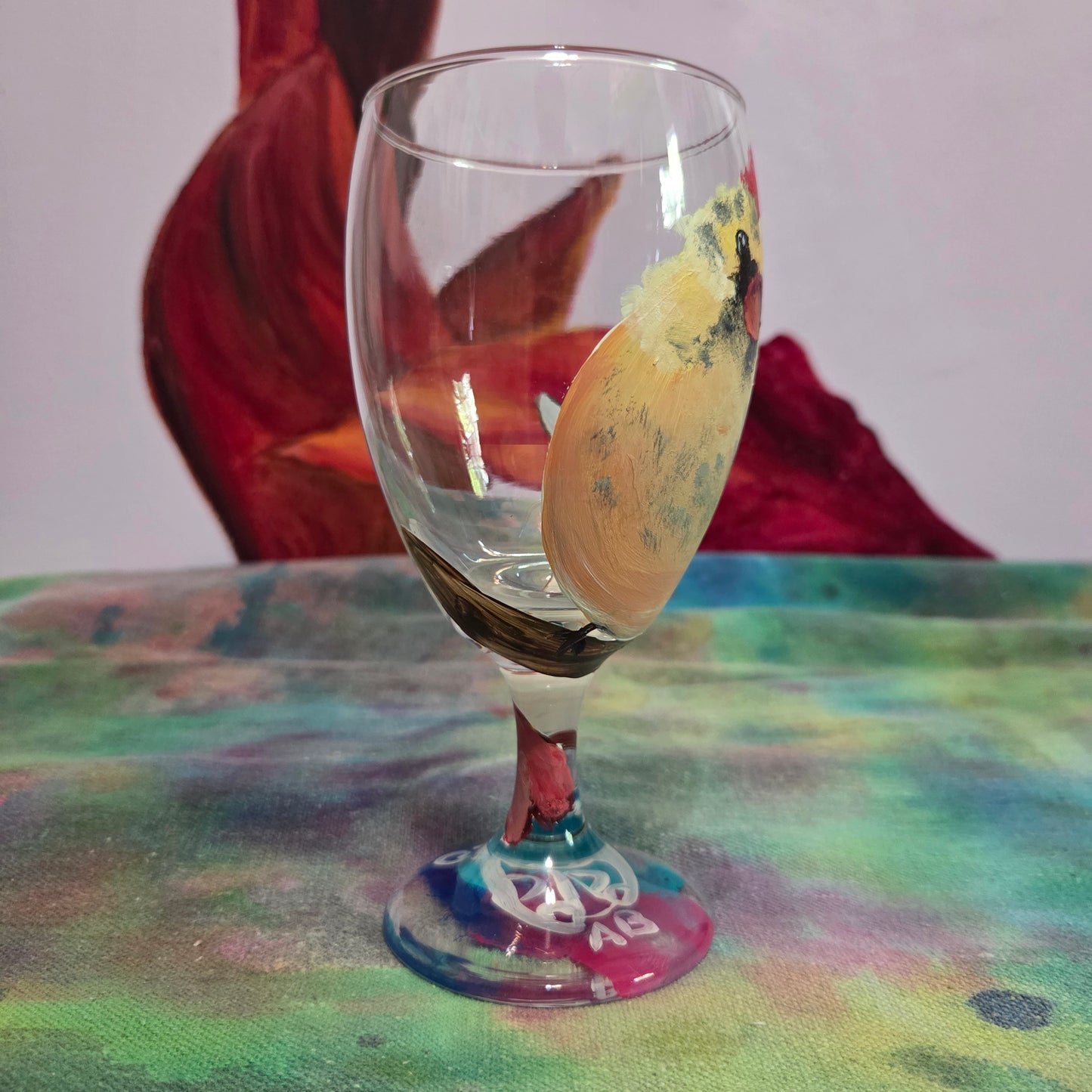 Hand-painted 16 oz goblet with a fluffy cream-colored female cardinal with pink accents and wings tucked behind her back