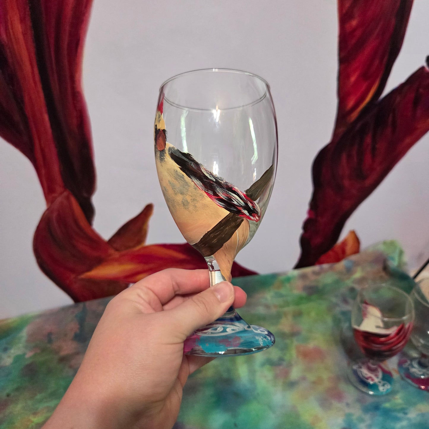 Hand-painted 16 oz goblet with a fluffy cream-colored female cardinal with pink accents and wings tucked behind her back