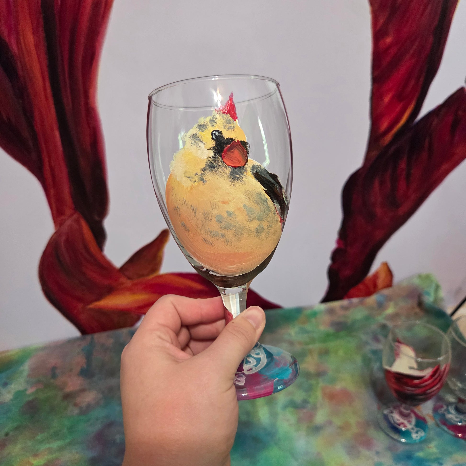 Hand-painted 16 oz goblet with a fluffy cream-colored female cardinal with pink accents and wings tucked behind her back