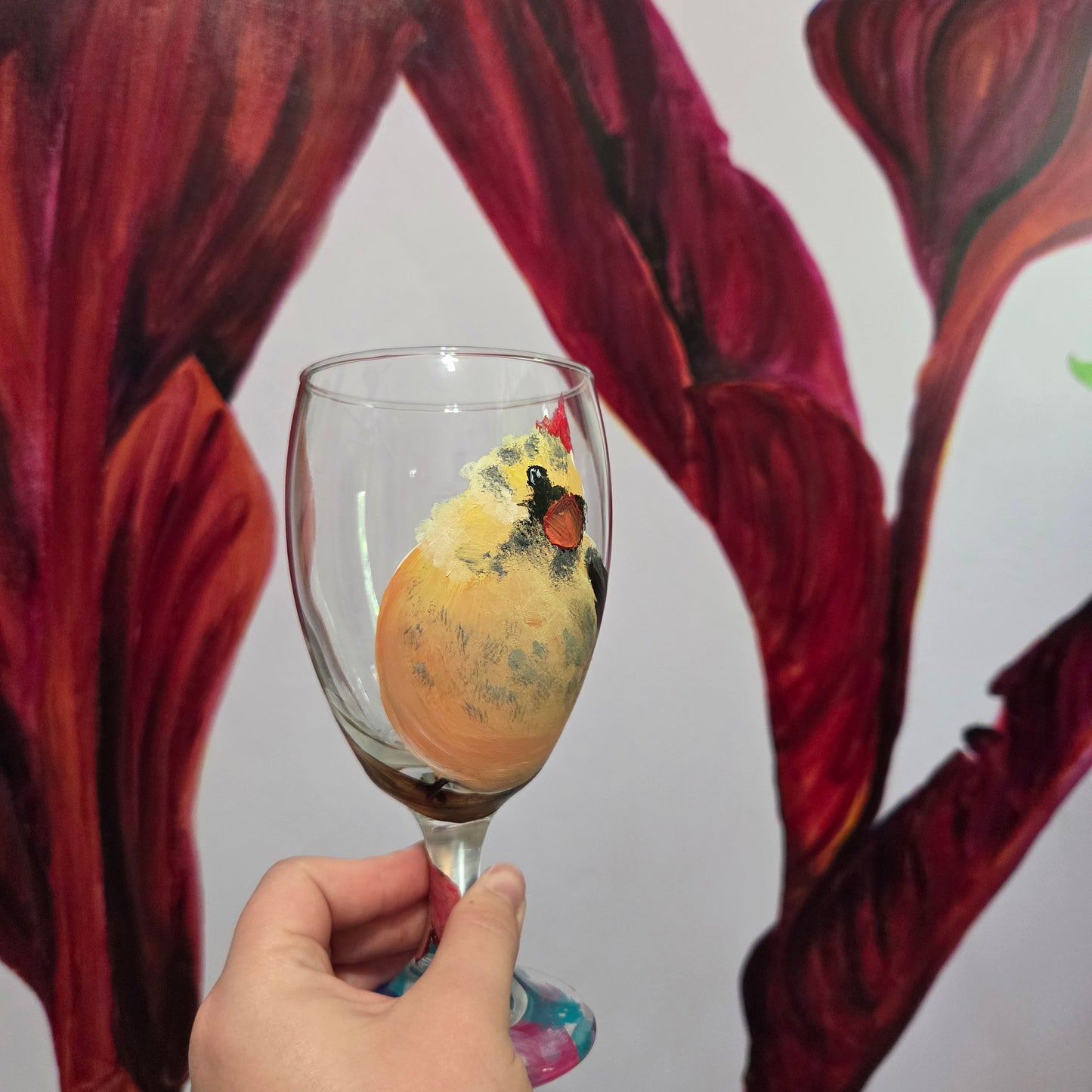 Hand-painted 16 oz goblet with a fluffy cream-colored female cardinal with pink accents and wings tucked behind her back