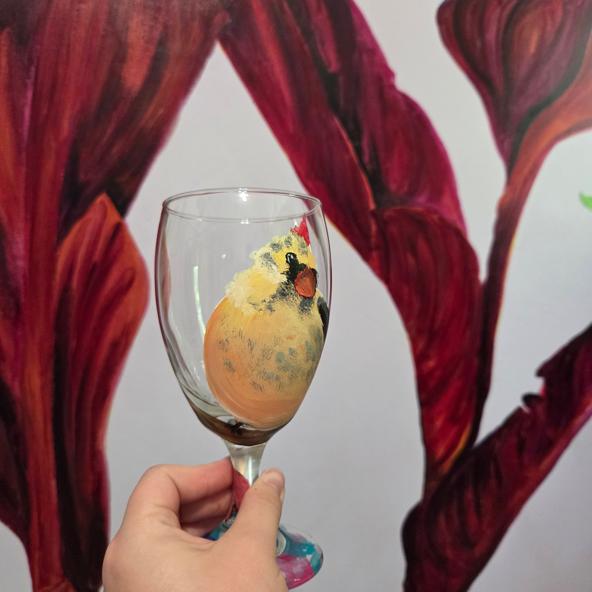 Hand-painted 16 oz goblet with a fluffy cream-colored female cardinal with pink accents and wings tucked behind her back