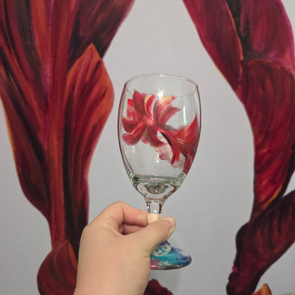 Hand-painted 16 oz goblet with a floating cardinal feather in red, orange, yellow, and subtle black shading