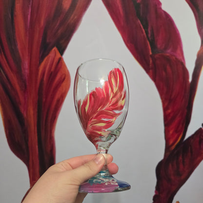 Hand-painted 16 oz glass with a graceful cardinal feather in brilliant red, orange, and golden yellow