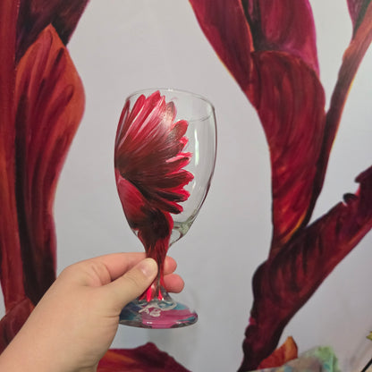 Hand-painted glass featuring a red male cardinal in flight looking down as he approaches his landing perch