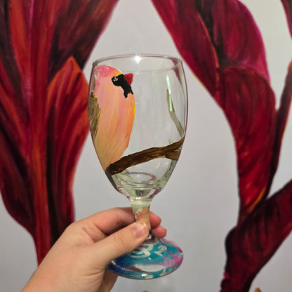 Hand-painted 16 oz glass with a pink-toned female cardinal perched on a branch and looking upward