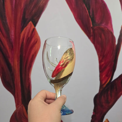 Hand-painted 16 oz glass with a pink-toned female cardinal perched on a branch and looking upward