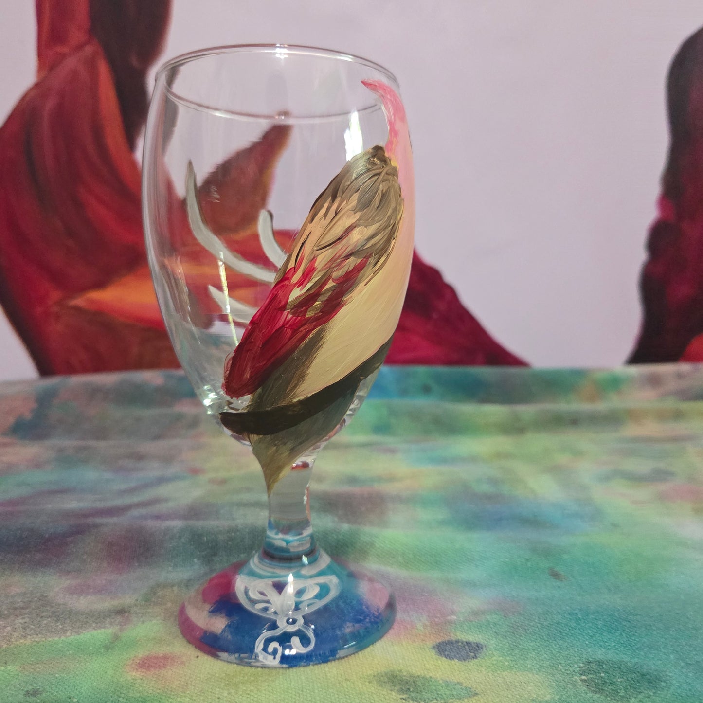 Hand-painted 16 oz glass with a pink-toned female cardinal perched on a branch and looking upward