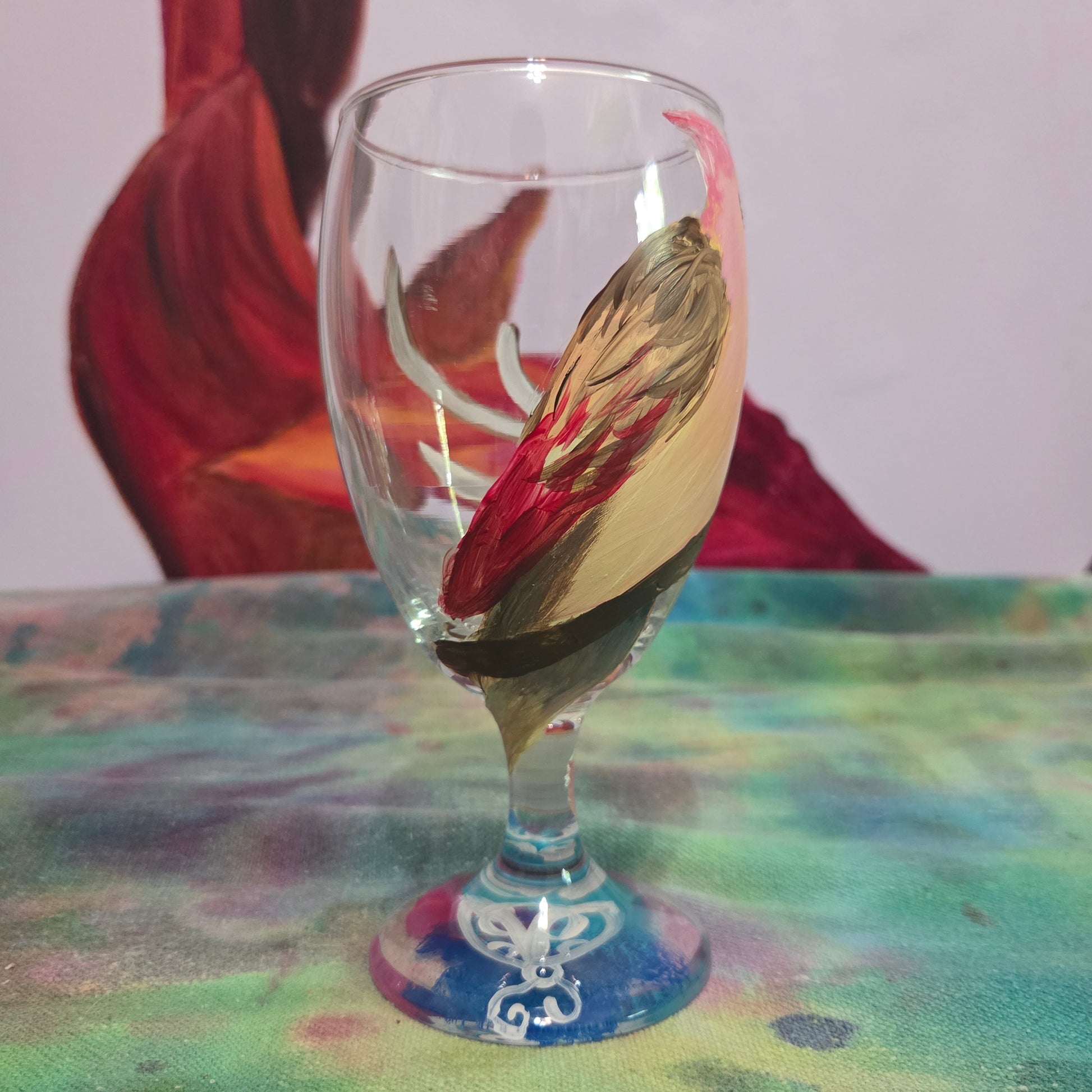 Hand-painted 16 oz glass with a pink-toned female cardinal perched on a branch and looking upward