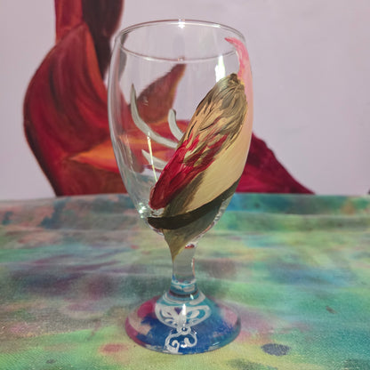 Hand-painted 16 oz glass with a pink-toned female cardinal perched on a branch and looking upward