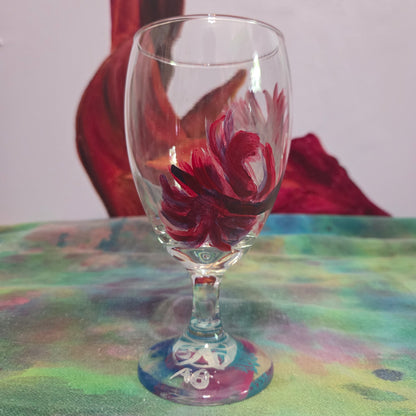 Hand-painted 16 oz goblet with a floating cardinal feather in bold red with black and subtle purple shadows