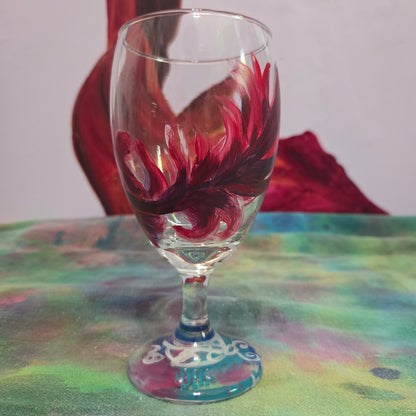 Hand-painted 16 oz goblet with a floating cardinal feather in bold red with black and subtle purple shadows