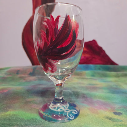 Hand-painted 16 oz goblet with a floating cardinal feather in bold red with black and subtle purple shadows