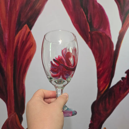 Hand-painted 16 oz goblet with a floating cardinal feather in bold red with black and subtle purple shadows