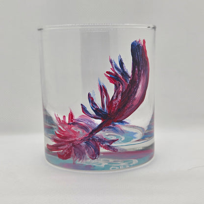 Hand-painted 11 oz short tumbler with a drifting cardinal feather in red, cobalt blue, and deep purple