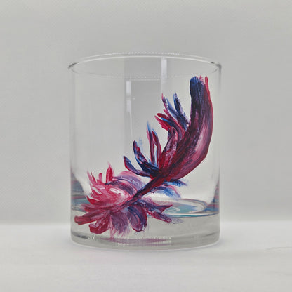 Hand-painted 11 oz short tumbler with a drifting cardinal feather in red, cobalt blue, and deep purple
