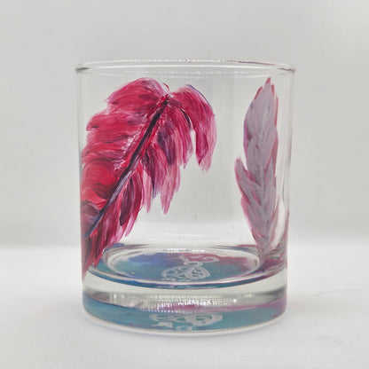 Hand-painted 11 oz short tumbler with two cardinal feathers in red, cobalt blue, and deep purple, one rising and one falling
