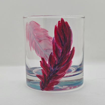 Hand-painted 11 oz short tumbler with two cardinal feathers in red, cobalt blue, and deep purple, one rising and one falling